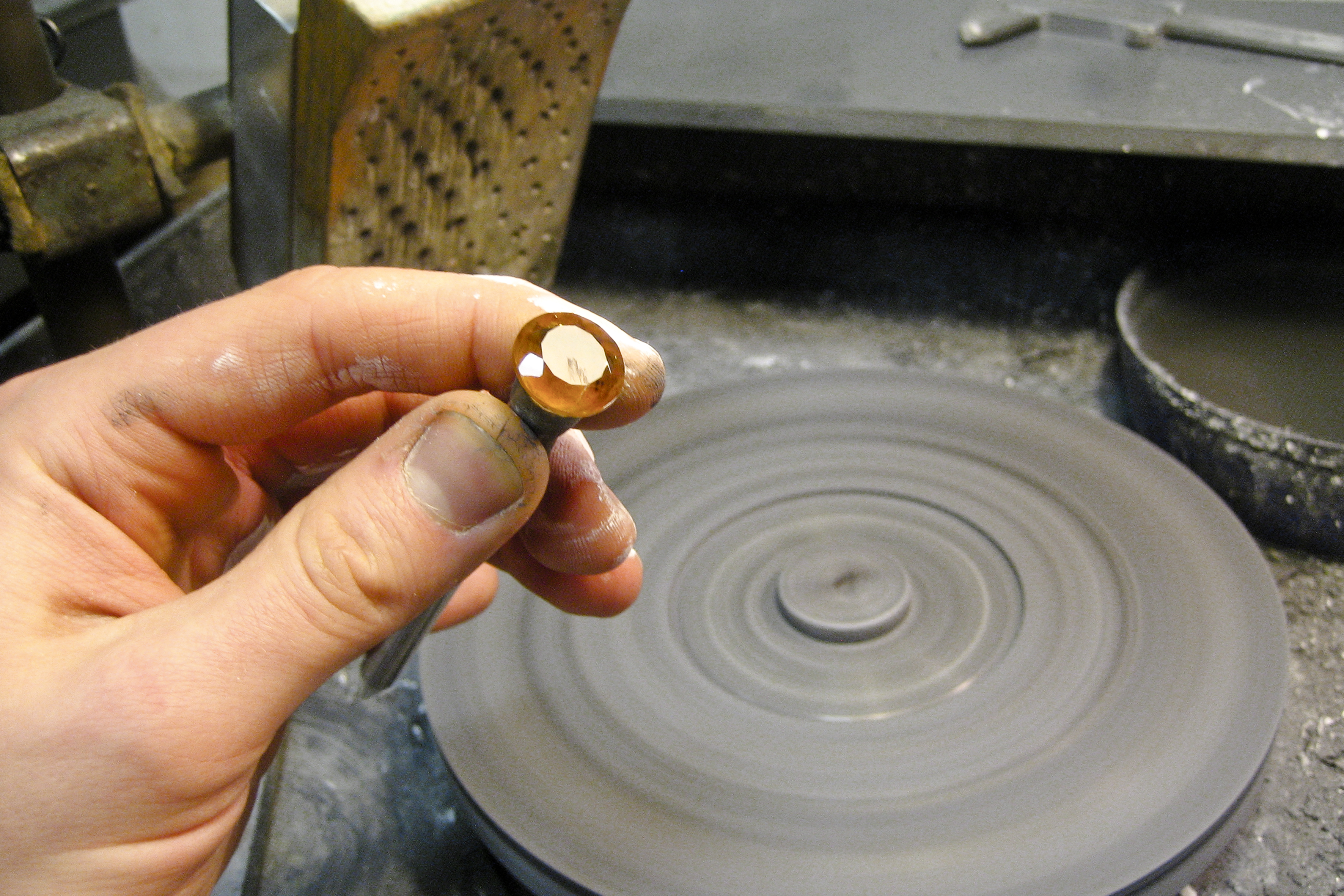 polishing the facets of a citrine stone